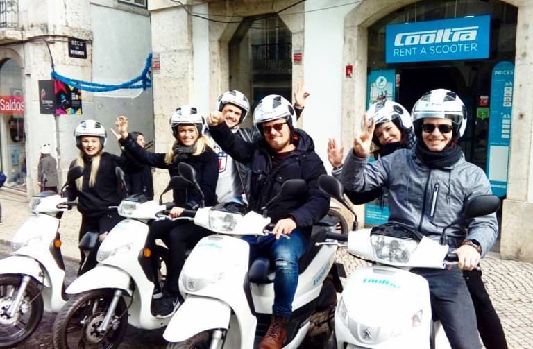 A row of rental scooters ready for exploration in Lisbon.