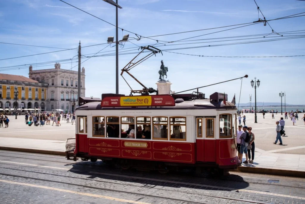 Tram 28 navigating through a charming Lisbon neighborhood.