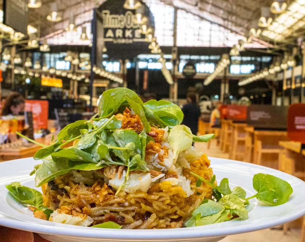 A delicious spread of dishes from various restaurants at Time Out Market in Lisbon.